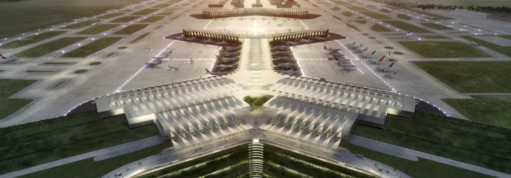 Aeropuerto de México: innovación, diseño y eficiencia en infraestructura aeroportuaria Vista frontal del aeropuerto de México con pistas iluminadas y diseño arquitectónico simétrico